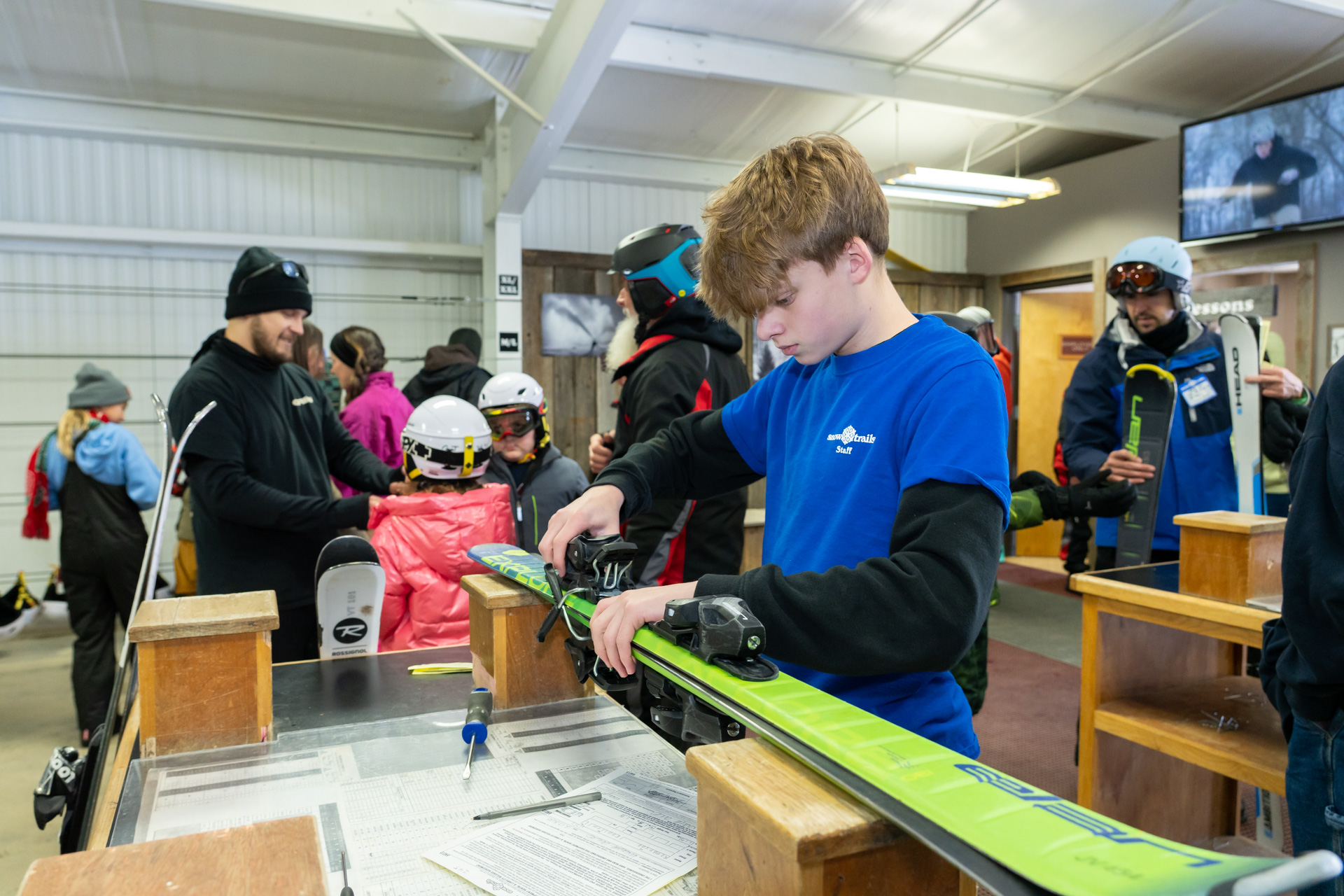 Rental Technician setting skis for Guest in Rental Center - Winter Employment at Snow Trails in Mansfield, Ohio